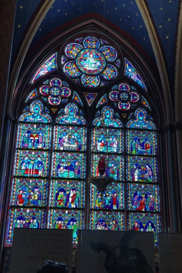 A great rose window of Notre-Dame glowing with stained glass
